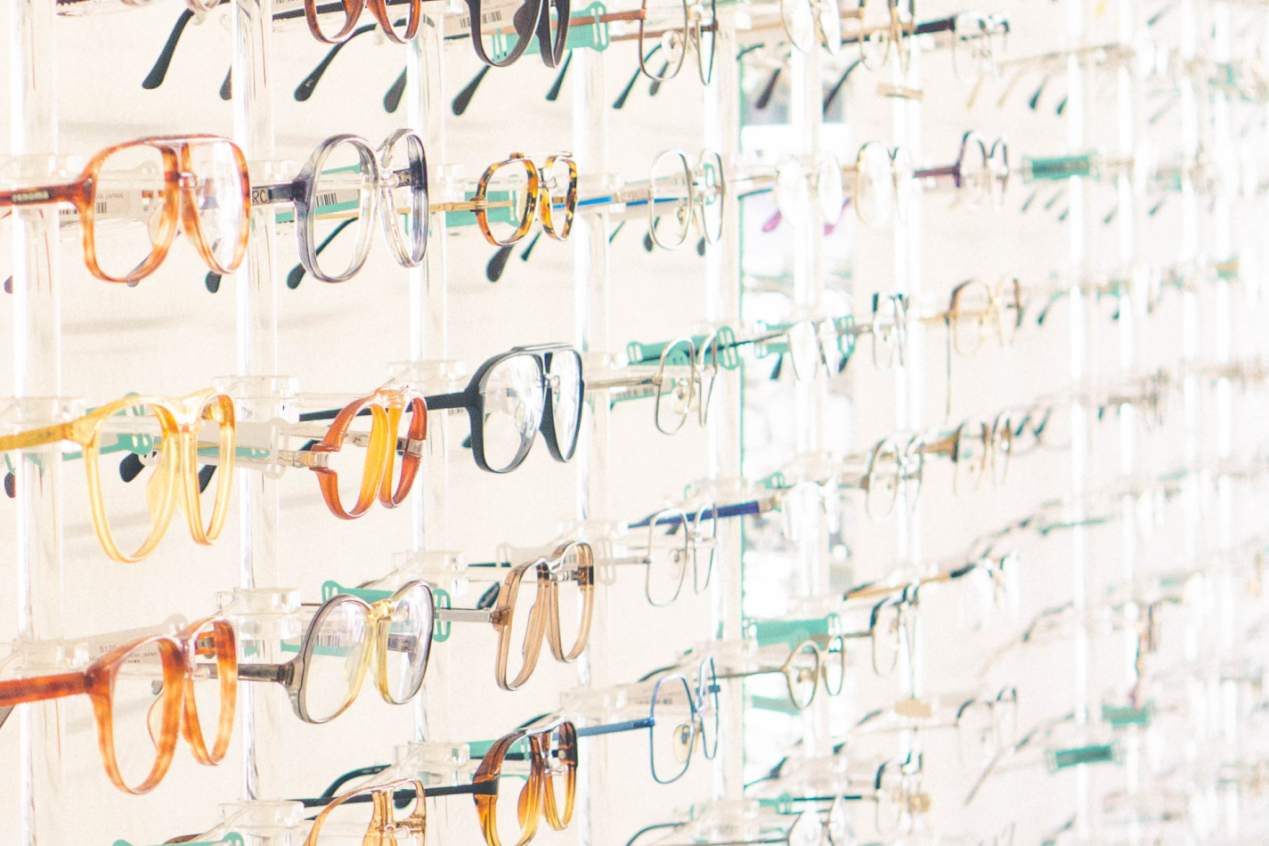 A wall display of funky vintages eyeglasses of all colors.